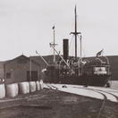 ss Outeniqua offloads petrol barrels which will be transported by donkey wagon to Willowmore. Early 20th Century