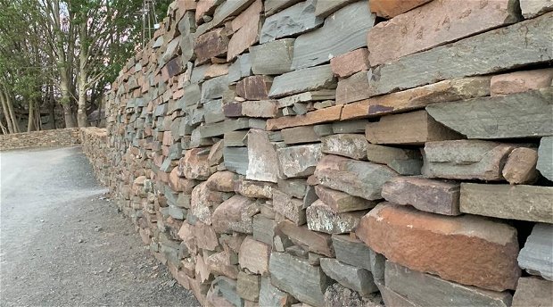 Old stone walls have been restored and new walls packed in the same Karoo style.