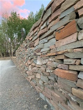 Old stone walls have been restored and new walls packed in the same Karoo style.