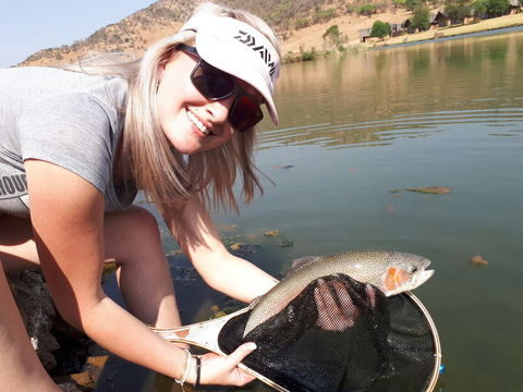 Women catching a Rainbow trout