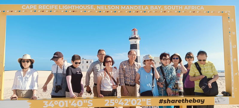 Guests on tour at Cape Recife Lighthouse, taking in breathtaking views and capturing special moments of fun and adventure along the stunning coastline.