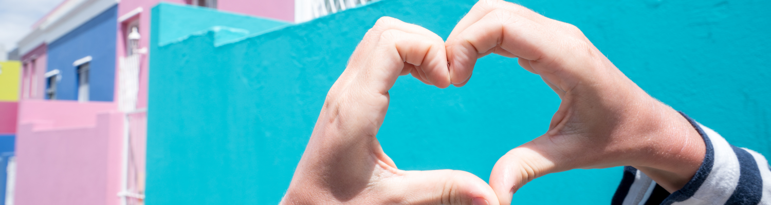 Person making heart shape in The bo-kaap
