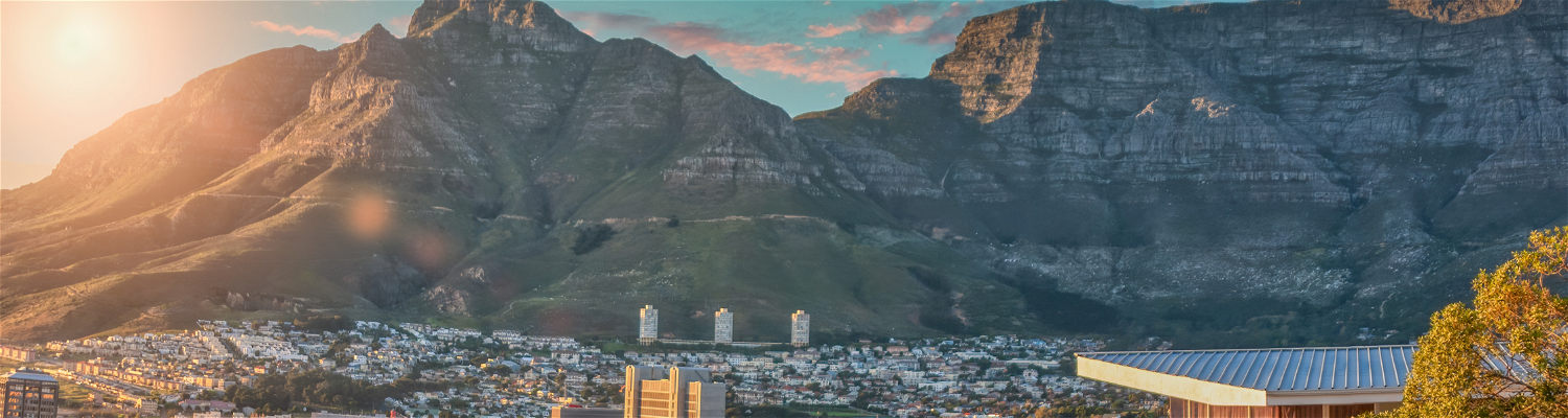 The photograph captures the stunning panoramic view of Cape Town City Bowl, with its iconic cityscape set against the magnificent backdrop of Table Mountain. 