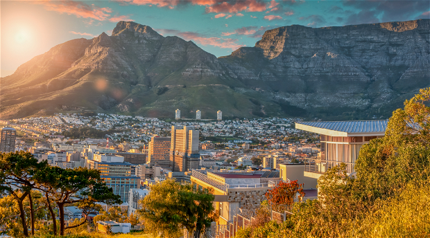 The photograph captures the stunning panoramic view of Cape Town City Bowl, with its iconic cityscape set against the magnificent backdrop of Table Mountain. 
