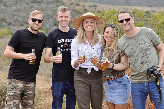 Tourists enjoying a Savanna cider drink at a lookout point in the Addo Elephant National Park on a guided Addo safari tour with Into Tours 