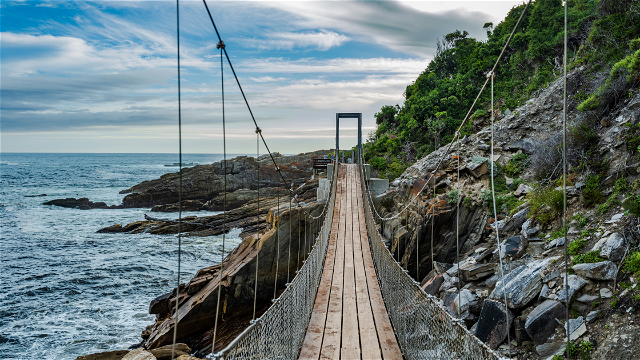 Storms River suspension bridge over looking the river mouth is located in the Tsitsikamma National Park. The 5 day Otter Trail starts at the Storms River mouth. Eastern Cape, South Africa 