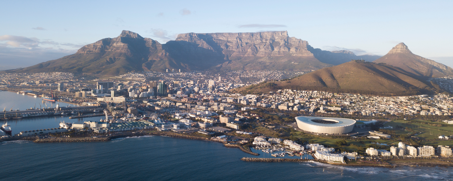 Photograph Arial view of Cape Town city, in South Africa. The picture includes the City Bowl, Table Mountain, Signal Hill, V&A Waterfront along with the Atlantic Seaboard and the Southern Suburbs of Cape Town. 