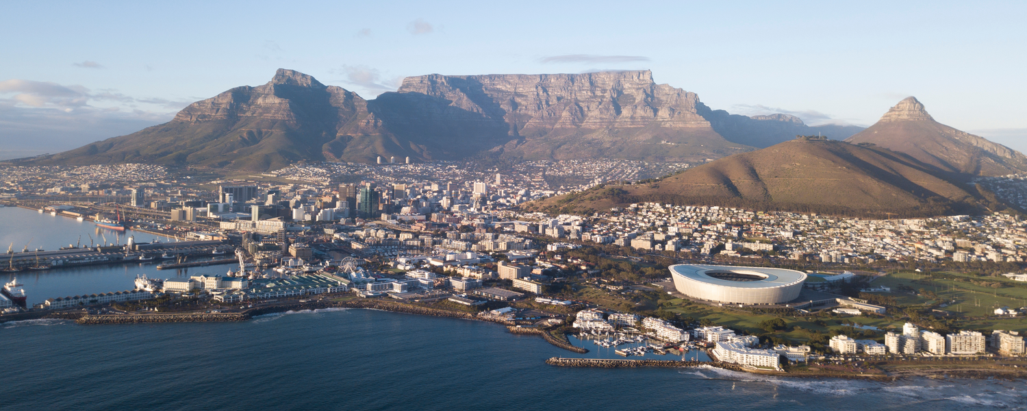 Photograph Arial view of Cape Town city, in South Africa. The picture includes the City Bowl, Table Mountain, Signal Hill, V&A Waterfront along with the Atlantic Seaboard and the Southern Suburbs of Cape Town.
