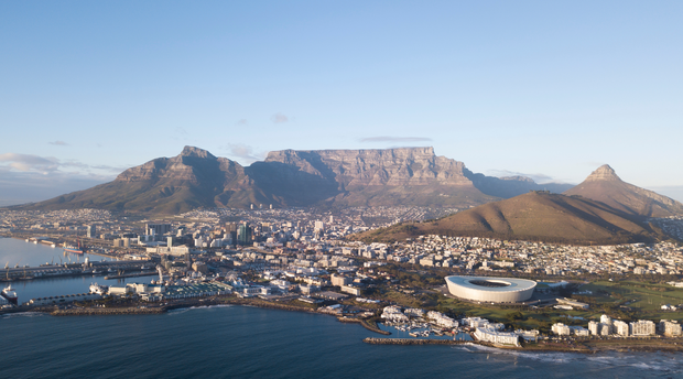 Photograph Arial view of Cape Town city, in South Africa. The picture includes the City Bowl, Table Mountain, Signal Hill, V&A Waterfront along with the Atlantic Seaboard and the Southern Suburbs of Cape Town. 