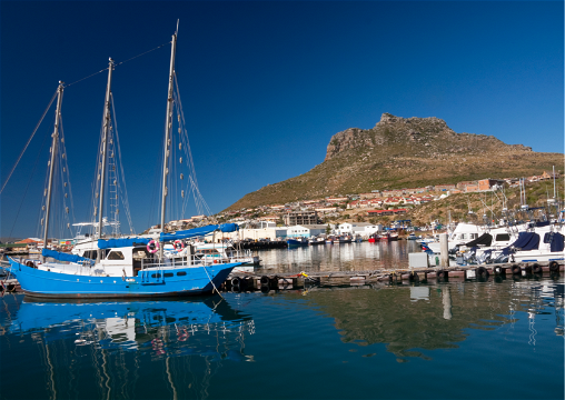 Boat docked at a seaside harbour along the Cape Peninsula in Cape Town