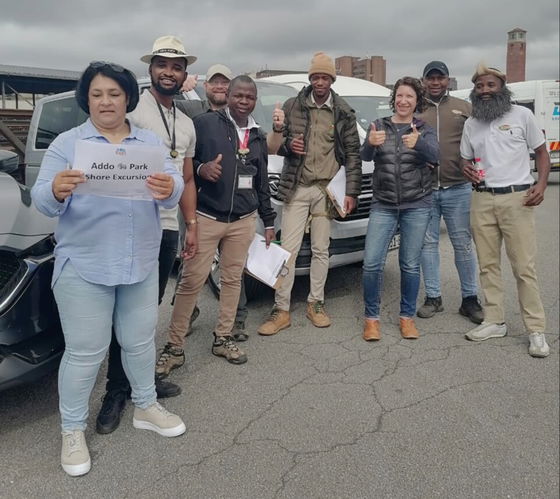 Smiling tour guides waiting to meet guest from cruise ship in Port Elizabeth Harbour