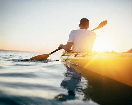 Man paddling a kayak 