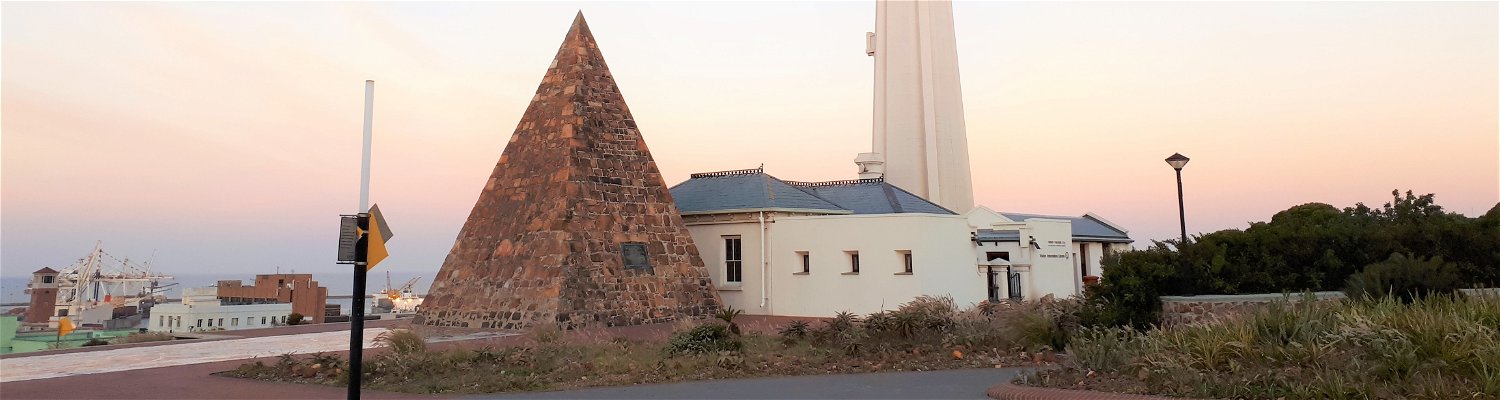 Captured at Donkin Reserve in Port Elizabeth (Gqeberha), South Africa, this picture of historic pyramid monument and iconic lighthouse 