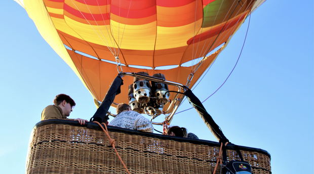 People that are in the basket of a Hot-Air-Balloon that is lifting off the ground in the Cape Winelands South Africa People that are in the basket of a Hot-Air-Balloon that is lifting off the ground in the Cape Winelands South Africa