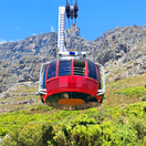 Table mountain in Cape Town, riding the table mountain cable car that summits to the top of Table Mountain as seen on a guided Cape Town tour with Into Tours, tour operator in Cape Town Table mountain in Cape Town, riding the table mountain cable car that summits to the top of Table Mountain as seen on a guided Cape Town tour with Into Tours, tour operator in Cape Town