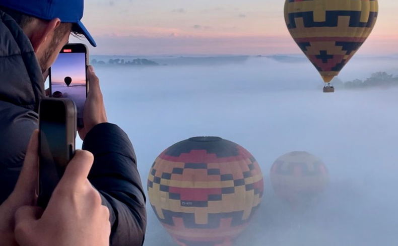 Looking at hot air balloons launching in the mist in The Cradle of Humankind, South Africa.