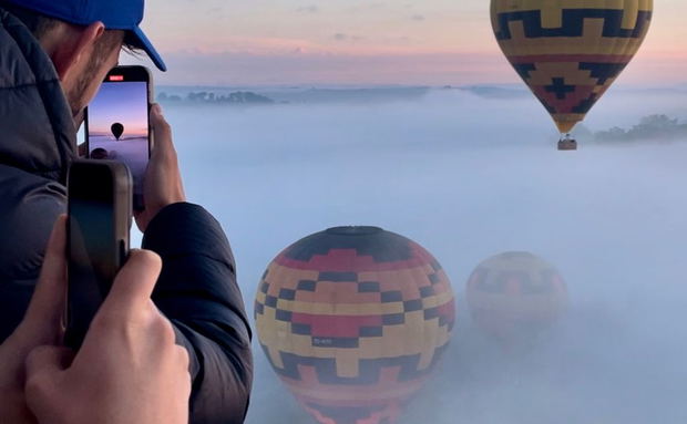 Looking at hot air balloons launching in the mist in The Cradle of Humankind, South Africa. Looking at hot air balloons launching in the mist in The Cradle of Humankind, South Africa.