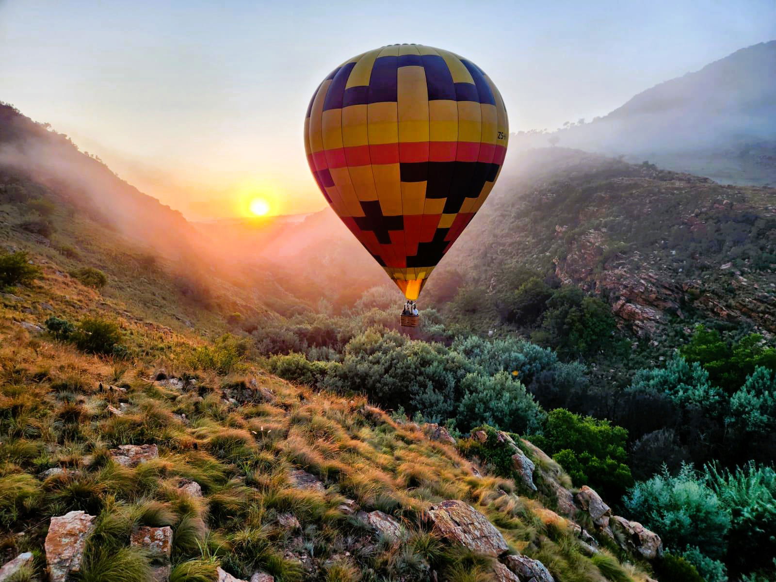 Hot Air Ballon flying through gorge