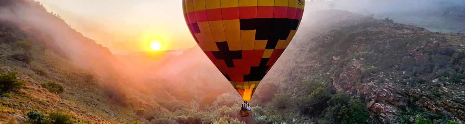 Hot Air Ballon flying through gorge