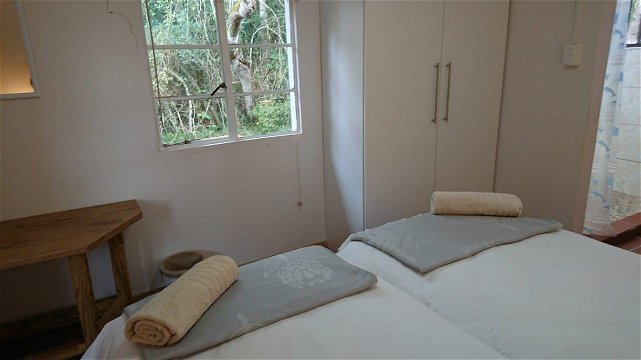 The Bush Pig Cottage main bedroom with en suite and forest views