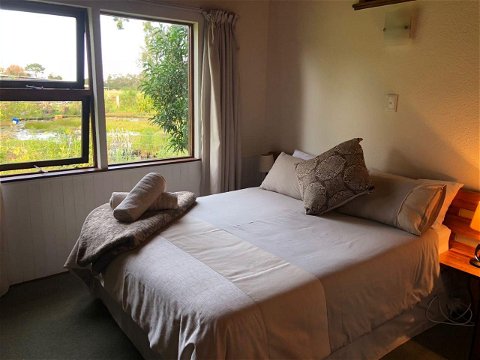 Double bed overlooking the pond at Natures Way Farm Cottage