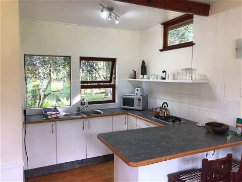 Fully equipped self-catering kitchen with gas kettle, stovetop, oven, toaster, microwave, bar fridge at Natures Way Farm Cottage