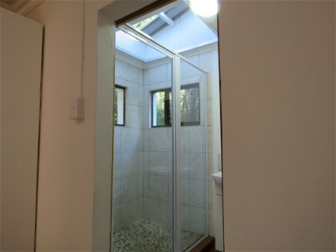 En suite bathroom with large shower and forest views 