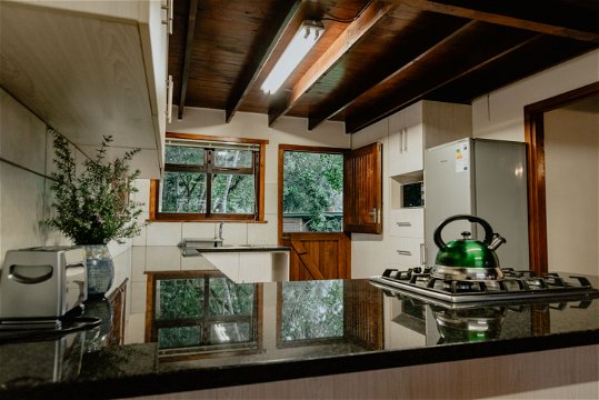 Fully equipped self-catering kitchen with gas kettle, stovetop, oven, toaster, microwave, fridge at The Wooden Forest House