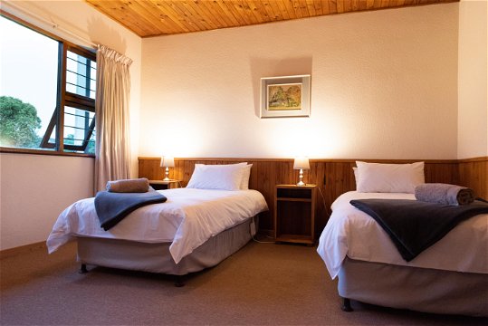 Two single beds in a spacious bedroom at Natures Way Farmhouse