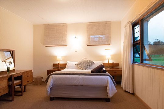 Double bed in the spacious main bedroom with large vanity dressing table and mirror at Natures Way Farmhouse