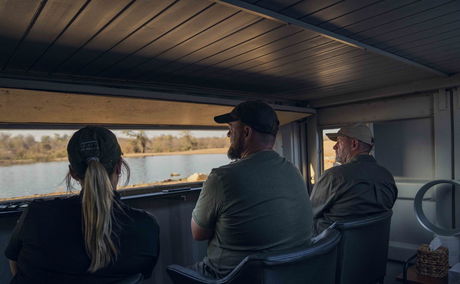 three photographers sitting in photographic bunker at Makumu Lodge