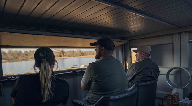 three photographers sitting in photographic bunker at Makumu Lodge