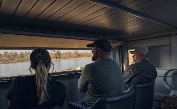 three photographers sitting in photographic bunker at Makumu Lodge