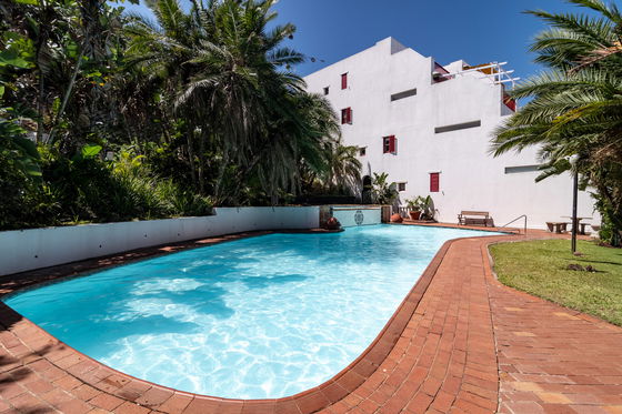 A crystal clear swimming pool is all that is needed at the end of a summers day.