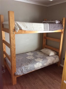 Bedroom with 4 wooden bunk beds