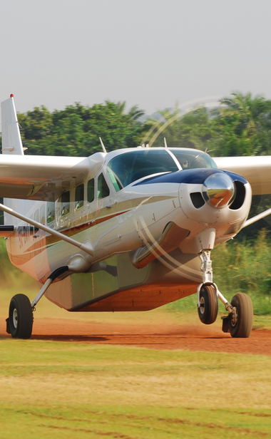 Cessna 208 Caravan taking off and flying across Uganda.