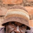 A portrait of a man smoking a pipe at Lake Bunyonyi, Uganda