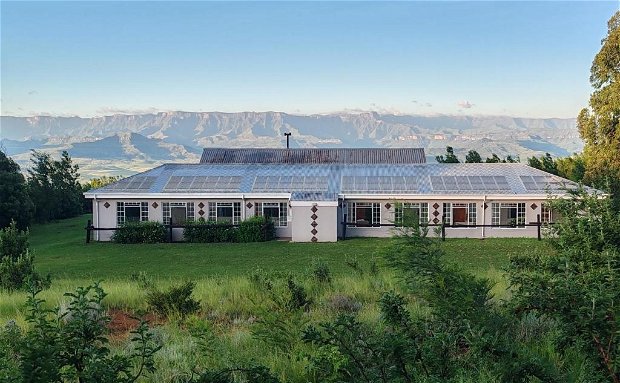 a nine bedroom holiday home in the Drakensberg Mountains can accommodate 25 guests comfortably and offers guests use of an indoor pool, full kitchen, dining room, lounge and outdoor braai area