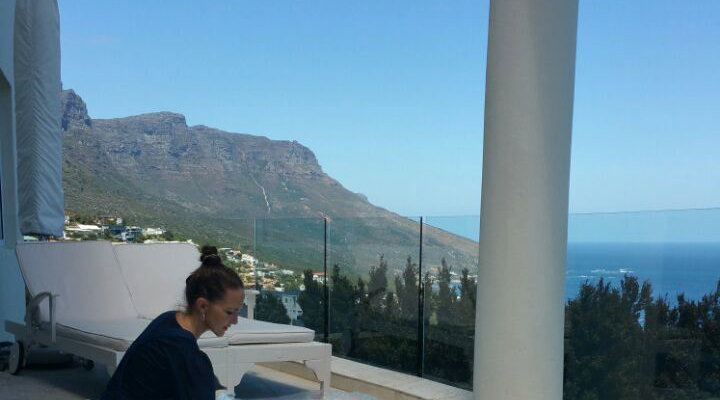 Jeannine Platz hand painting her Suite View of Camps Bay at Atlantique Villa Camps Bay