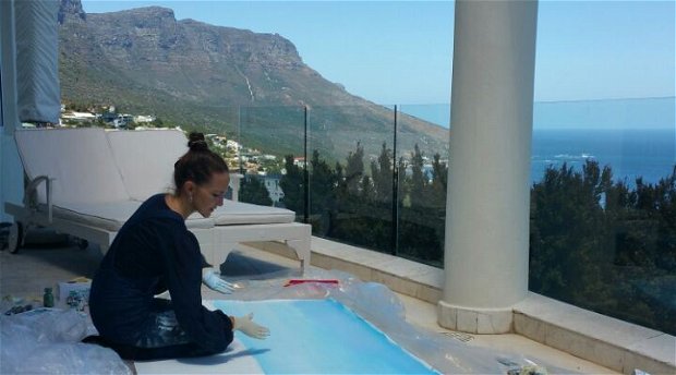 Jeannine Platz hand painting her Suite View of Camps Bay at Atlantique Villa Camps Bay