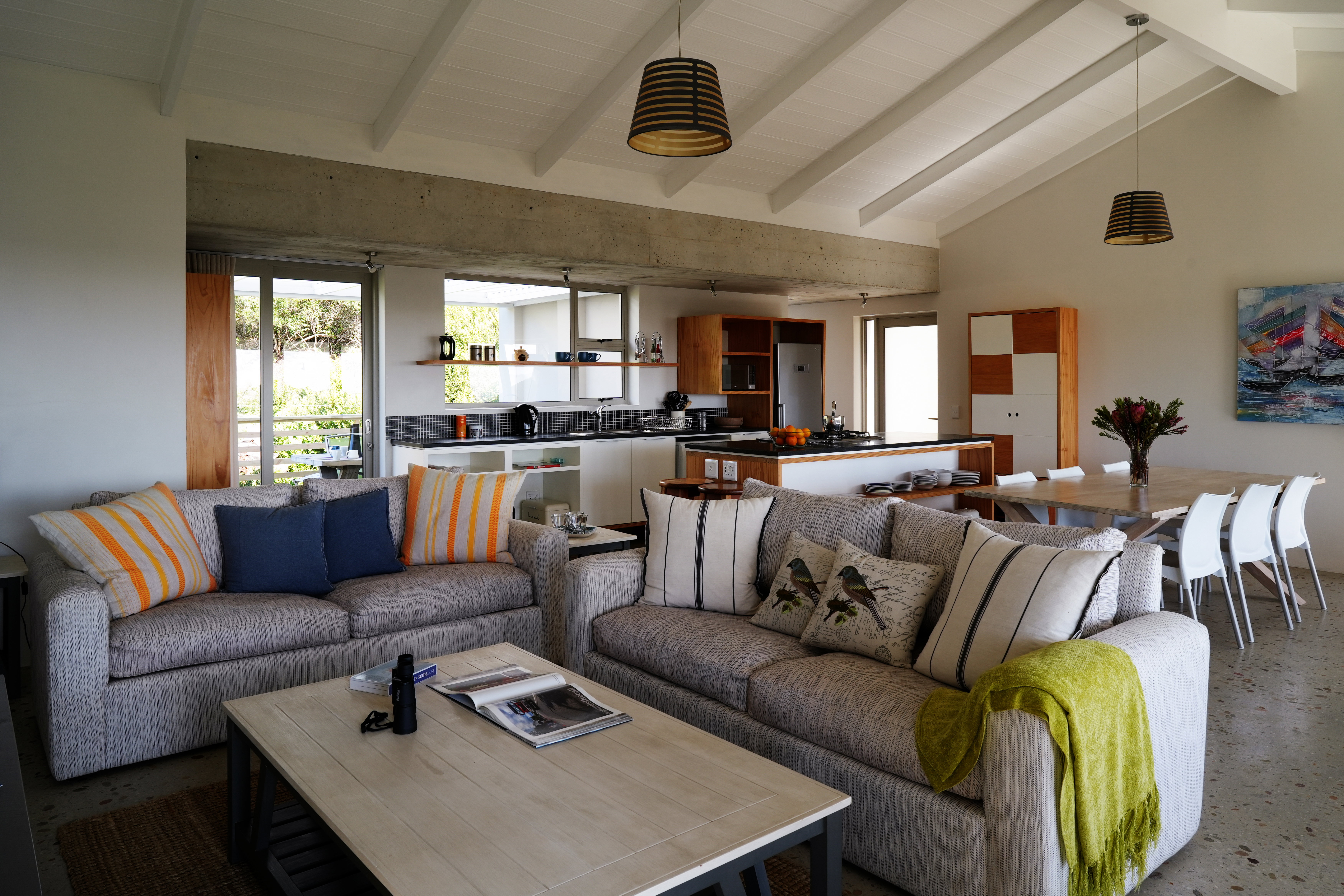 The spacious living room , kitchen, dining floor leads onto two verandas and the swimming pool.