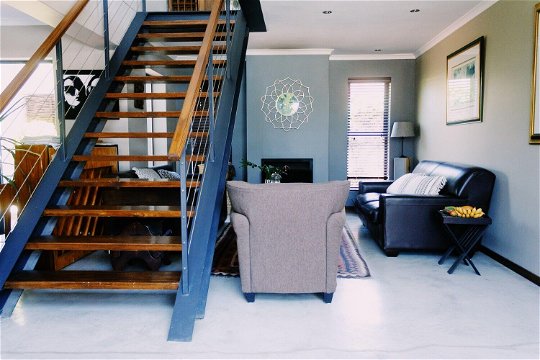 Indoor stairway access to Constantiaberg Suite 