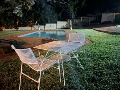 Sitting area near swimming pool at night
