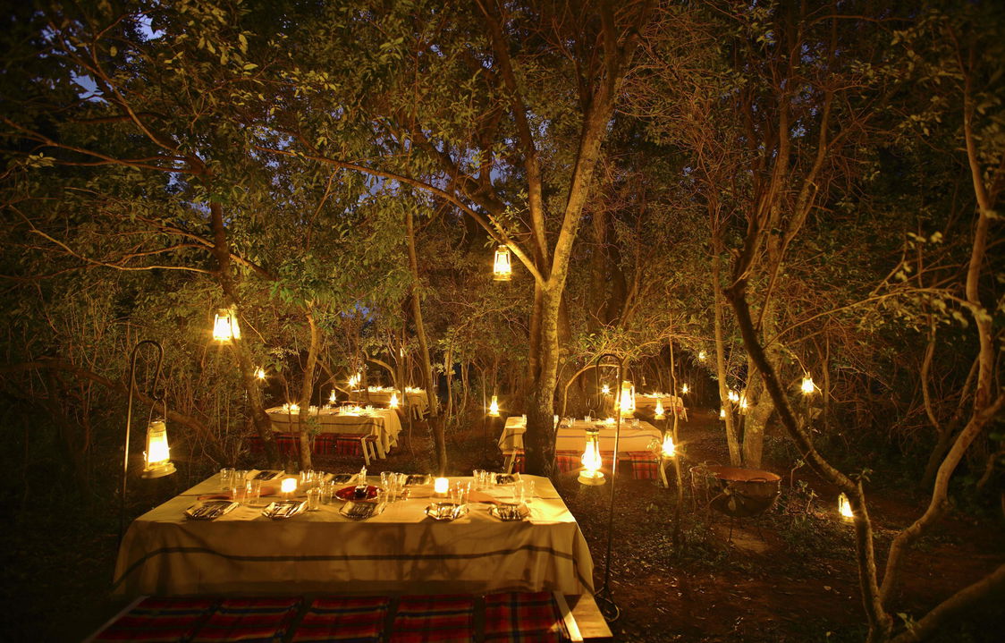 tables in bush set up for a bush dinner at Angama Mara Kenya Masai Mara