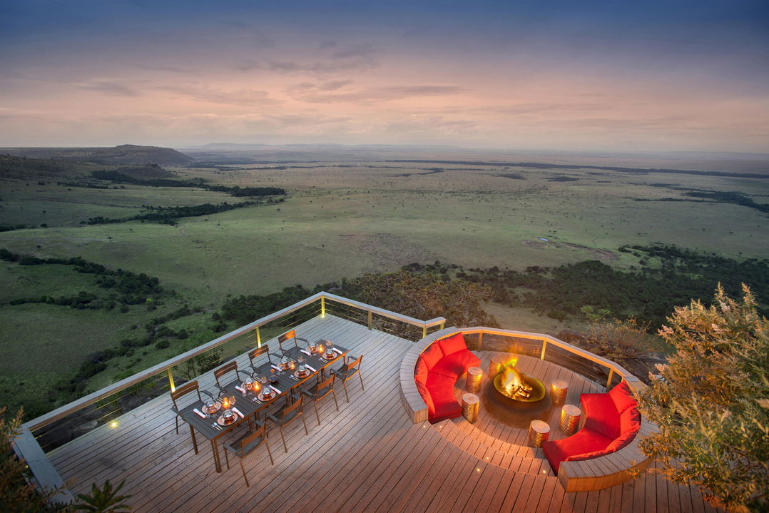 dinner tables by fireplace on deck of Angama Mara Kenya Masai Mara