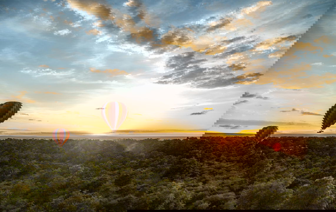 hot air balloon over the Mara at sunrise by Angama Mara Kenya Masai Mara