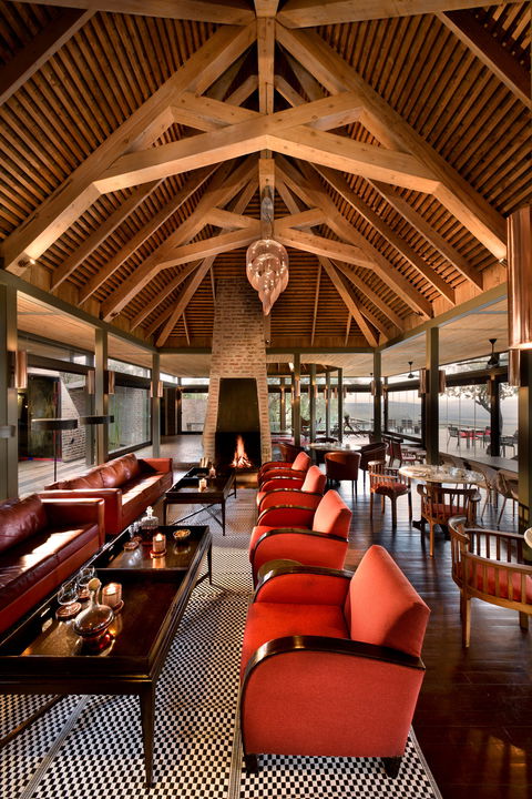 lounge area by fireplace inside Angama Mara Kenya Masai Mara