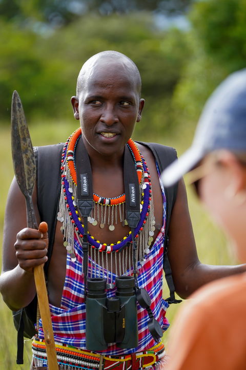 Masai tracker talking to guests of Angama Mara Kenya Masai Mara