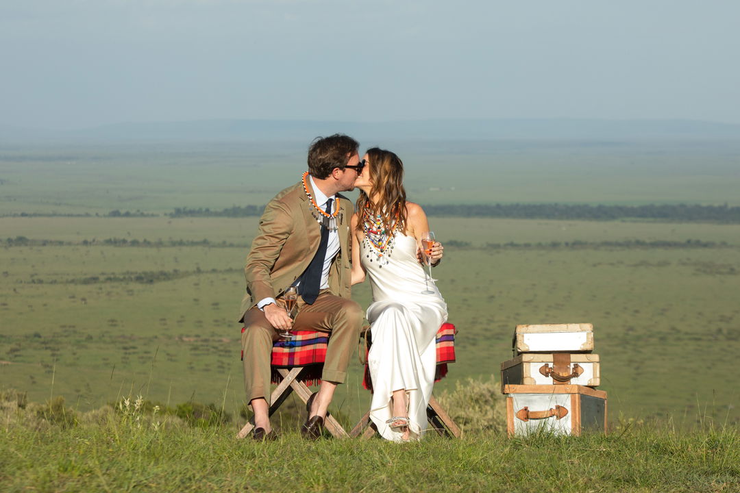 wedding couple kissing on a hill with views at Angama Mara Kenya Masai Mara