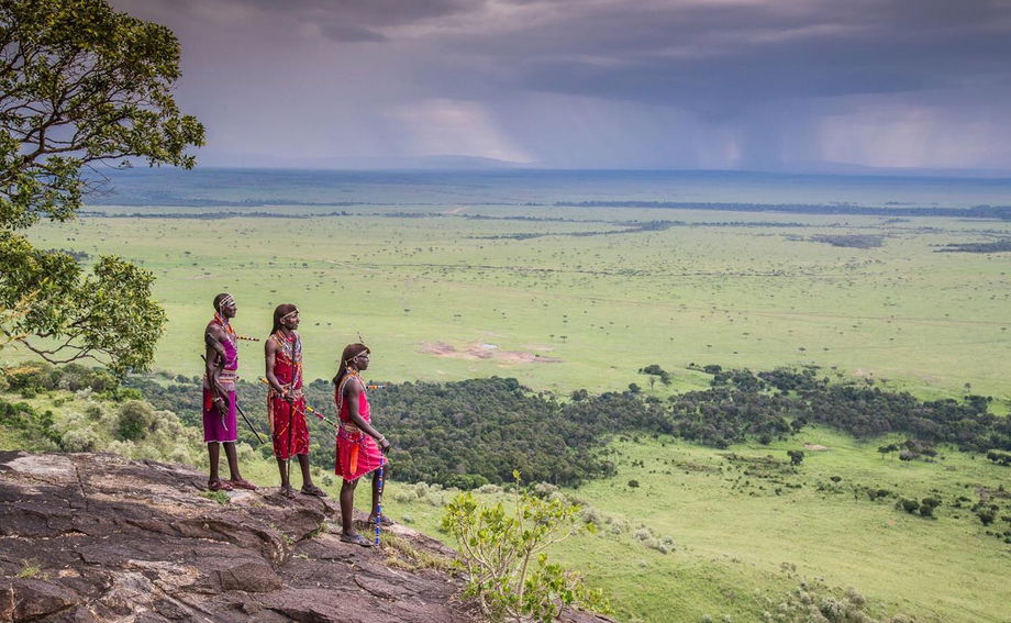 Masai rangers on a hilltop overlooking plains by Angama Mara Kenya Masai Mara